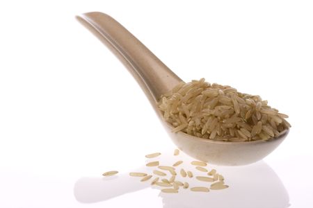 Isolated mage of brown rice in a spoon.の写真素材