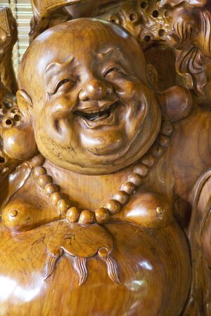 Image of a carved wooden Buddha statue at Shangrila Park, Guilin, China.の写真素材