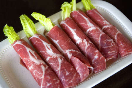 Image of raw sliced lamb rolls.の写真素材