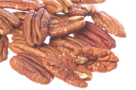 Isolated macro image of pecan nuts.