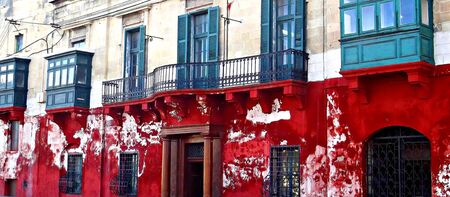 red facade with green balconiesの写真素材