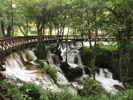 Bosnia's enchanting Jajce Waterfall: Nature's masterpiece in a serene setting, bridgeの写真素材