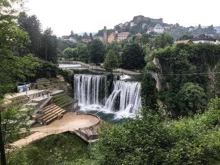 Bosnia's enchanting Jajce Waterfall: Nature's masterpiece in a serene settingの写真素材