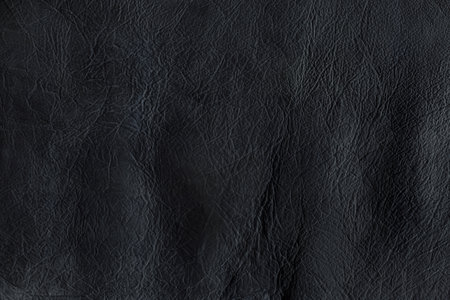 Black bright macro photo of texture of the genuine faux vegan leather. Fashion pattern and background. Leather with embossing.の写真素材