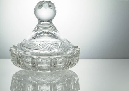 Crystal bowl with reflection on illuminated white backgroundの写真素材
