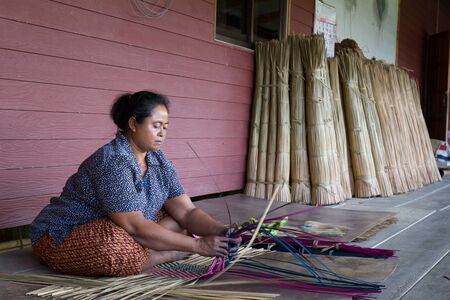 Talaynoi, Phatthalung province, Thailand - May 16, 2015 :  The unidentified native women working on traditional hand made mat.のeditorial素材