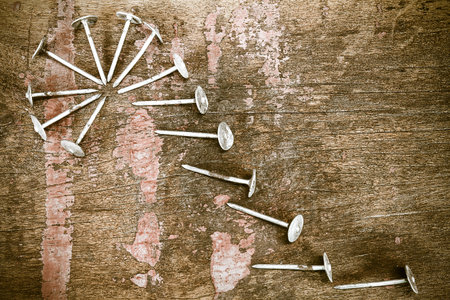 Old grunge rusty nails on vintage wooden background in vintage styleの写真素材