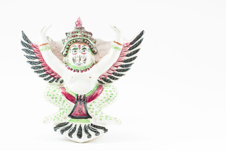 Antique ceramic Thai garuda statue on white backgroundの写真素材