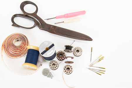 Old grunge sewing accessories on white backgroundの写真素材