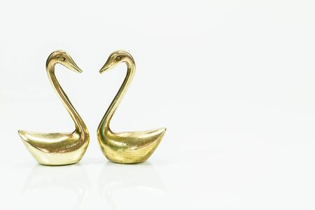 Rusty antique brass swan statue on white backgroundの写真素材