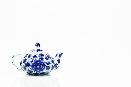 Vintage blue ceramic teapot on white backgroundの写真素材
