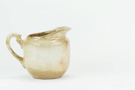 Old grunge vintage white ceramic milk jar isolated on white backgroundの写真素材