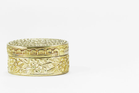 Old antique vintage rusty carved brass ware isolated on white backgroundの写真素材