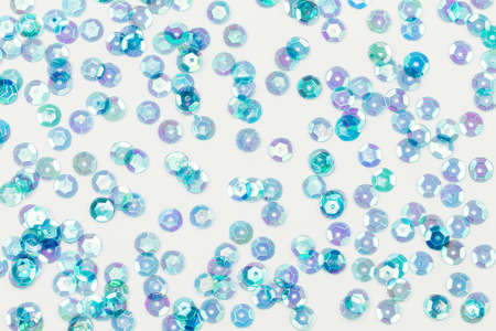 Blue sequins texture on white backgroundの写真素材