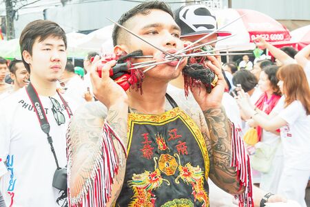 Phuket, Thailand - Oct 18, 2015 : Unidentified participant performing body piercing,  Phuket vegetarian festival. It is annually event.のeditorial素材