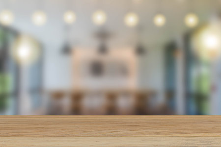 Vintage wooden tabletop on blurred coffee shop background, for display or montage your products