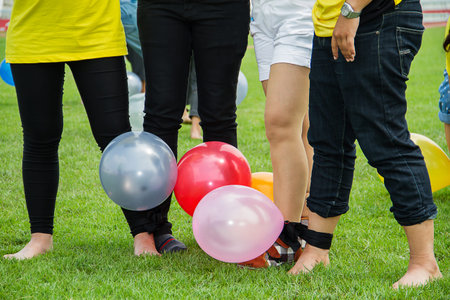 People playing games on green grass field in company's sport day, harmony concept