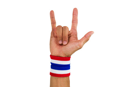 Thai national color cloth wristband on the guy's wrist making I love you sign on white backgroundの写真素材