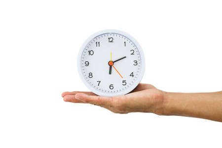 Man hand holding alarm clock isolated on white background
