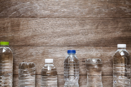 Drinking water bottle on grunge vintage wooden backgroundの写真素材