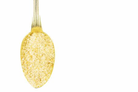 Sugar on brass spoon isolated on white backgroundの写真素材