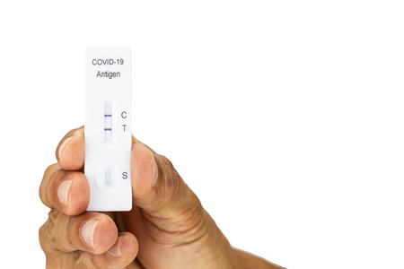 Hand showing Covid-19 self antigen rapid test kit with positive result on white background with...