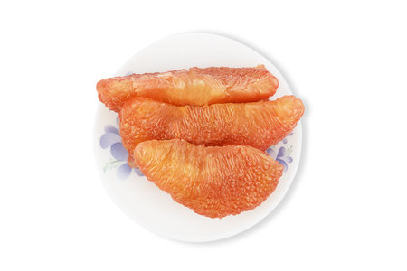 Fresh pealed pomelo on white plate, top viewの写真素材