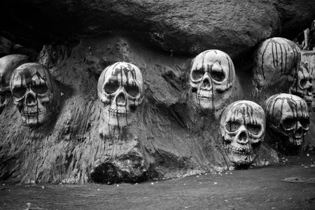 Human skulls in stone with blood sculpture black and white.