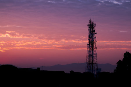 Silhouettes telecommunication tower at sunrise and twilight cloud and sky.