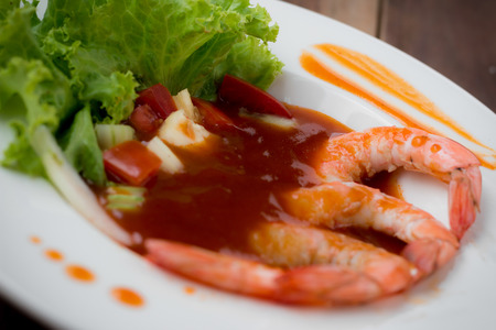 sweet and sour shrimp, prawn cocktail on dish and wooden tableの写真素材