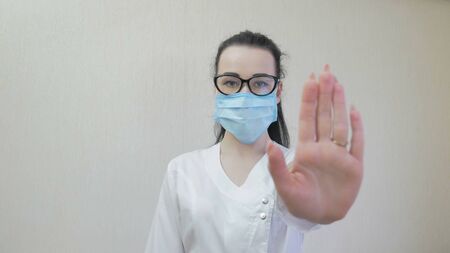 Close up of nurse in the medical mask. Portrait of the girl in protection mask.の写真素材
