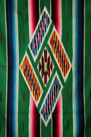Colorful central medallion of a woven mexican sarape.