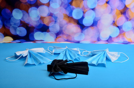 White christmas Angels and the fallen Dark Angel from face protection mask on blue background. COVID-19. Christmas concept on pendemic. Copy space.の写真素材