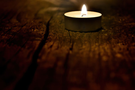 Many small christmas candles burning at dark. Shallow depth of field, selective focusの写真素材