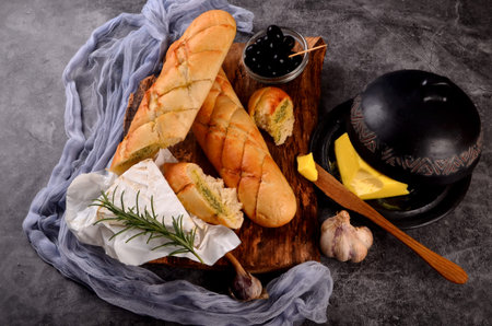 Garlic bread.Garlic and Herb Butter Baguettes on dark background