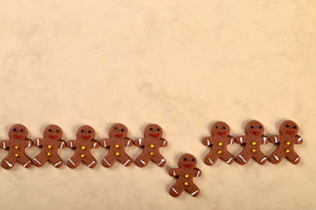 gingerbread hearts and Many Gingerbread men on a beige background. Christmas card conceptの写真素材