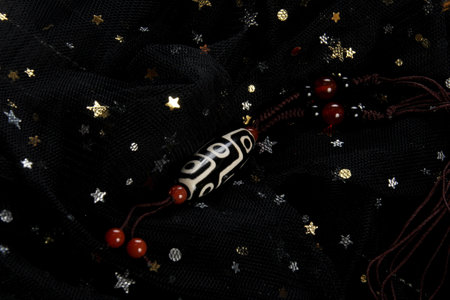 Tibetan 9 Eyes Dzi Beads necklace.Tibet Antique Buddhist Old Necklace Pendant. Tibet amulet. Dark background with incense sticksの写真素材