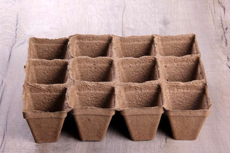 Empty peat pots on gray wooden background. Peat pots for seedlingの写真素材