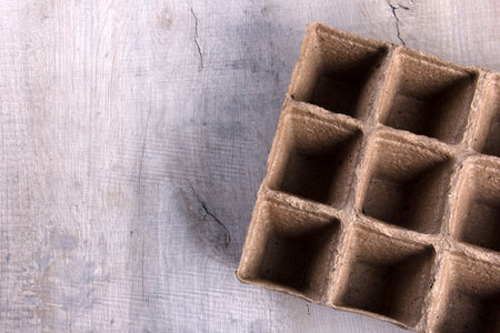 Empty peat pots on gray wooden background. Peat pots for seedling