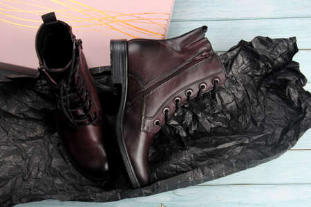 Riga, Latvia, february 27, 2021: Women's ankle boots in burgundy leather. Fashionable women's boots in burgundy on a thick heel. Leather boots for women.のeditorial素材