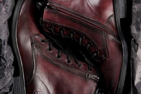 Riga, Latvia, february 27, 2021: Women's ankle boots in burgundy leather. Fashionable women's boots in burgundy on a thick heel. Leather boots for women.のeditorial素材