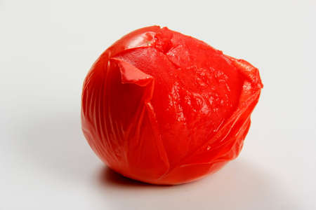 blanched red tomatoes on a white background, ready for peelingの写真素材