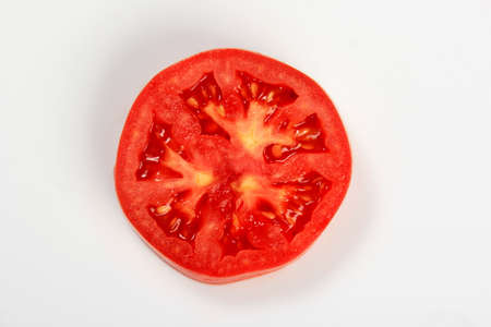Red Tomato slice isolated on white background, top view. Slice of tomato isolated on whiteの写真素材