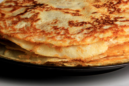 Pancakes on the black plate.Stack of tasty pancakes on white background. delicious pancakes in a...