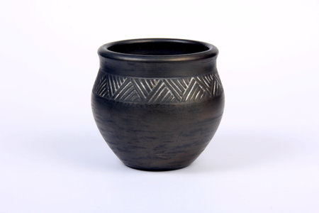 Small black empty ceramic bowl isolated on white.black clay pot on a white backgroundの写真素材