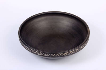 Small black empty ceramic bowl isolated on white.black clay pot on a white backgroundの写真素材