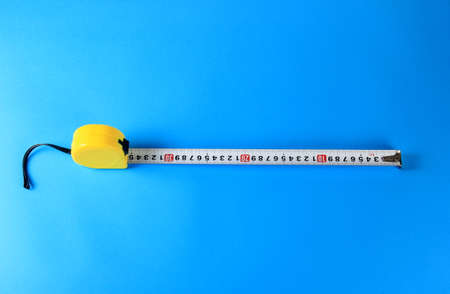 Yellow Measuring Tape on color background. Copy space.の写真素材