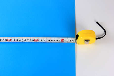 Yellow Measuring Tape on color background. Copy space.の写真素材