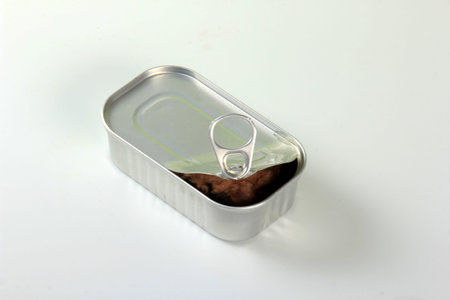 Opened Tin can with cod liver on a white background. Open tin container with cod liver isolated on...