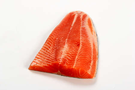 Raw trout fillet isolated on white background. Raw orange salmon fish filletの写真素材